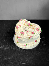 Load image into Gallery viewer, Elegant bespoke cake by Kaki Desserts, featuring intricate floral decorations and a smooth frosting finish.