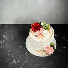 Load image into Gallery viewer, Elegant bespoke cake from Kaki Desserts with intricate floral decorations and a smooth, colorful icing finish.