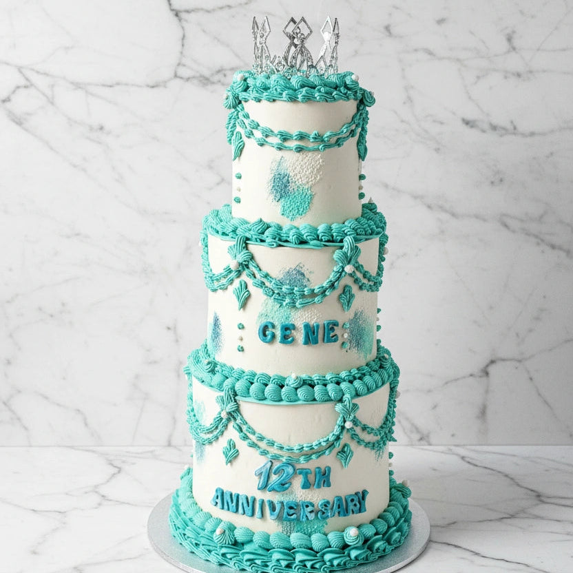 Marble tier cake from Kaki Desserts with layered white and gray marble design on a cake stand.