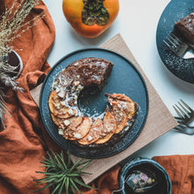 Load image into Gallery viewer, Rich chocolate bundt cake from Kaki Desserts, showcasing a glossy glaze and decorative chocolate shavings.