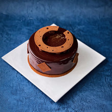 Load image into Gallery viewer, Delicious bespoke cake by Kaki Desserts, featuring intricate frosting and decorative elements on a stylish cake stand.