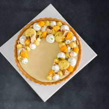 Load image into Gallery viewer, Bespoke cake by Kaki Desserts featuring yuzumango and passionfruit decoration on a smooth frosting surface.