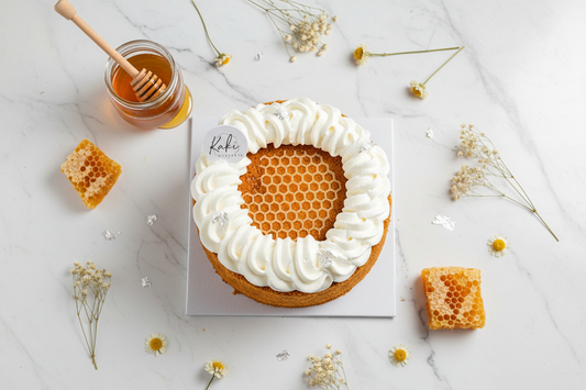 Kaki Desserts bestseller honey cake flat lay with honeycomb and flowers