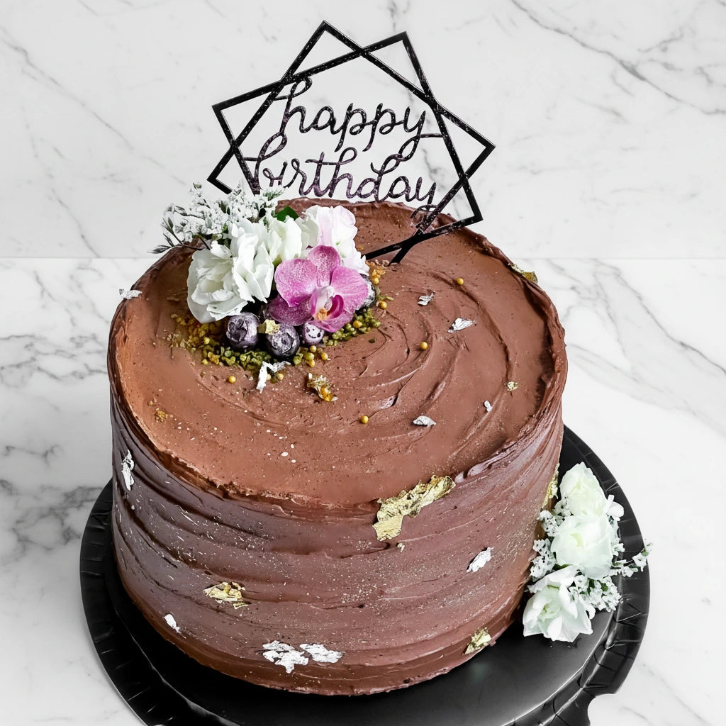 Decorative marble cake with 100-day lily design from Kaki Desserts, showcasing elegant floral and marbled frosting details.