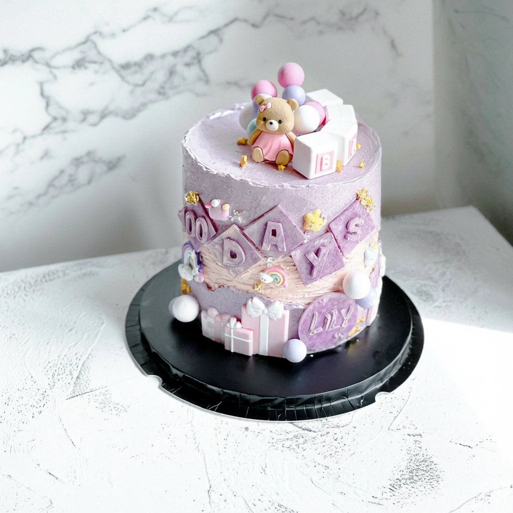 Decorative marble cake with 100-day lily design from Kaki Desserts, showcasing intricate floral piping on a smooth cake surface.