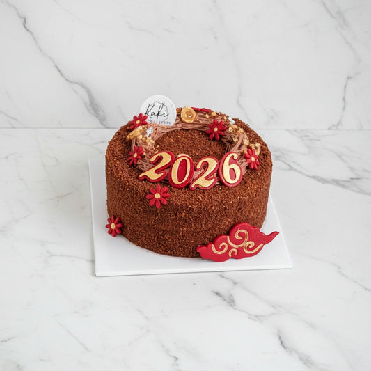 Chocolate Hazelnut by Kaki Desserts with '2026' decoration on a marble surface