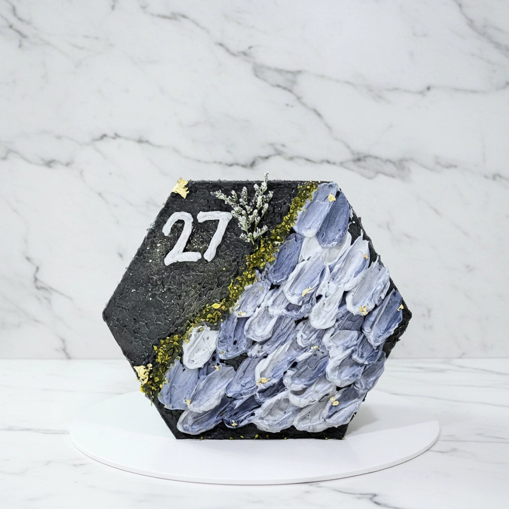 Hexagonal marble cake from Kaki Desserts with a smooth, elegant marble pattern and a glossy finish on top.