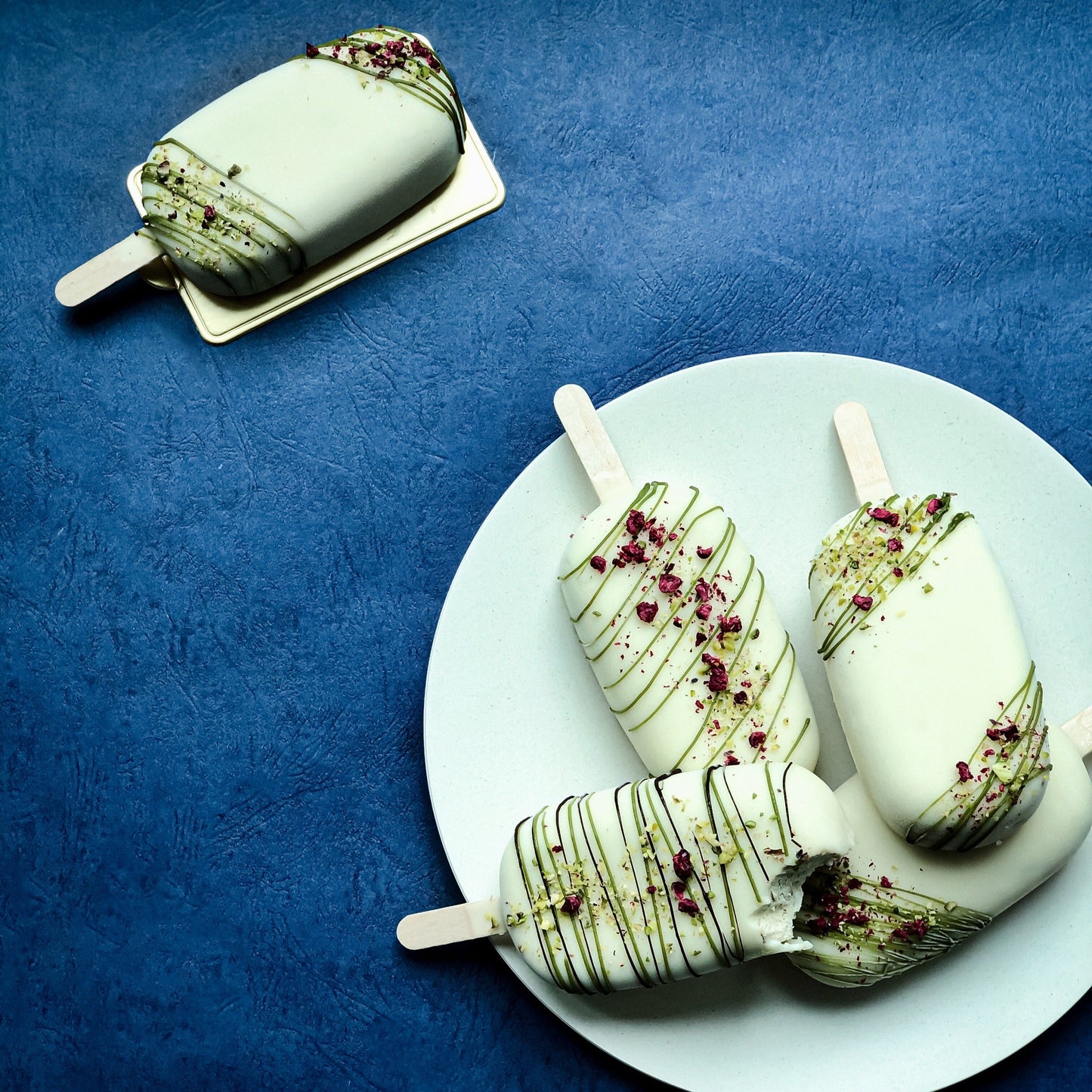 Decorative bespoke cake from Kaki Desserts with intricate floral icing and elegant design for special occasions.