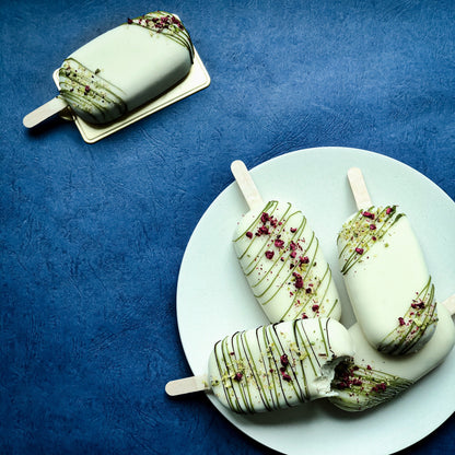 Decorative bespoke cake from Kaki Desserts with intricate floral icing and elegant design for special occasions.