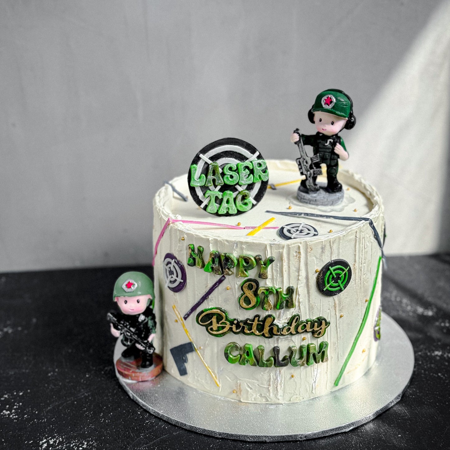 Decorative bespoke cake from Kaki Desserts with floral and elegant piping details, displayed on a white cake stand.