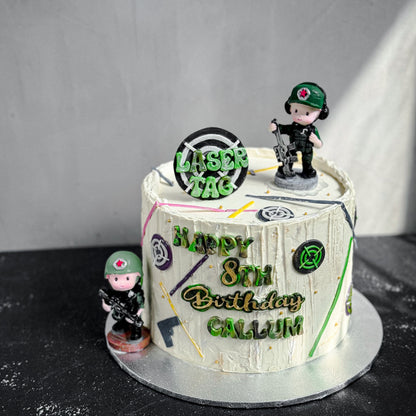 Decorative bespoke cake from Kaki Desserts with floral and elegant piping details, displayed on a white cake stand.