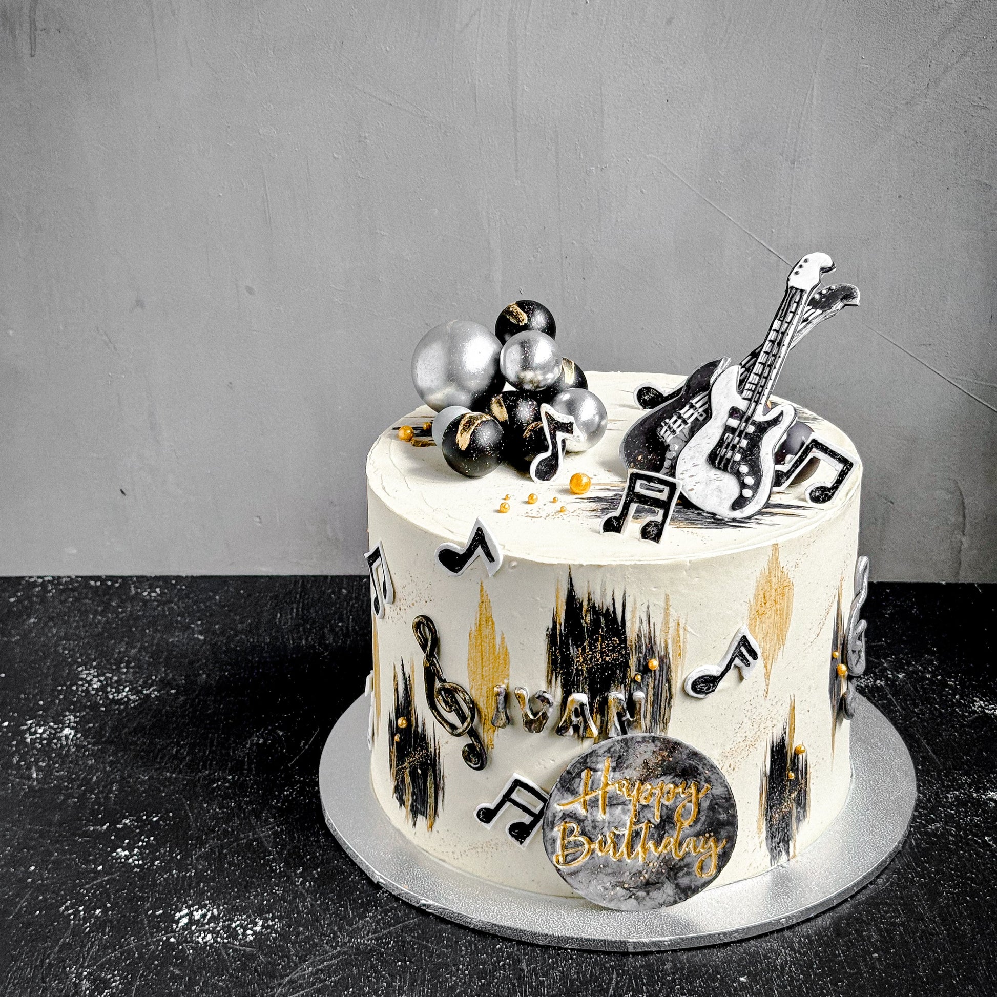 Decorative bespoke cake from Kaki Desserts with intricate icing floral designs on a white background.