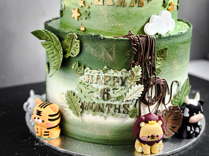 Assorted bespoke cakes from Kaki Desserts with intricate frosting and decorative toppings on a white plate.