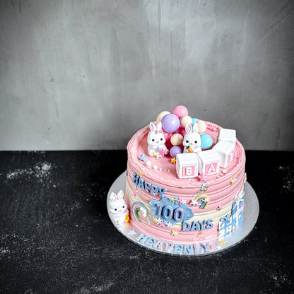 Close-up of a beautifully decorated bespoke cake from Kaki Desserts with intricate icing and colorful floral accents.