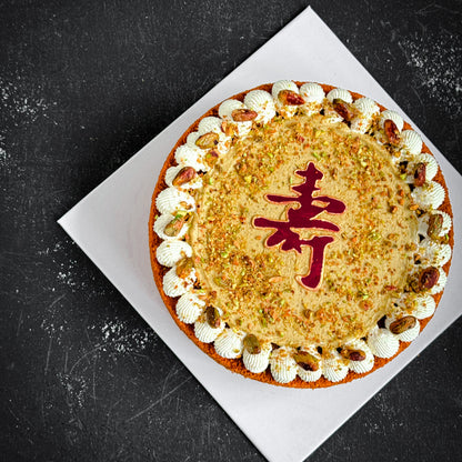 Decorative bespoke cake from Kaki Desserts with intricate floral and geometric icing designs on a white cake base.