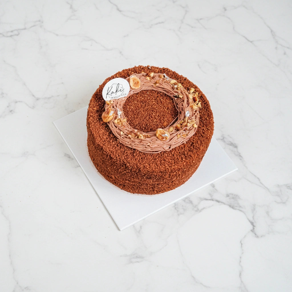 Honey Chocolate Hazelnut by Kaki Desserts with '2026' decoration on a marble surface