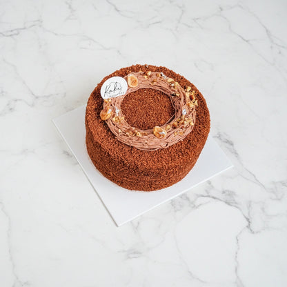 Honey Chocolate Hazelnut by Kaki Desserts with '2026' decoration on a marble surface