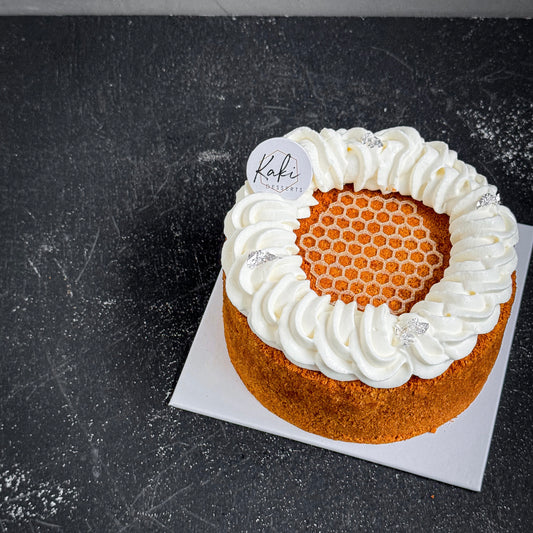 Kaki Desserts Honeybee refined sugar-free sweetener in a clear jar with a golden lid, close-up of the product label.