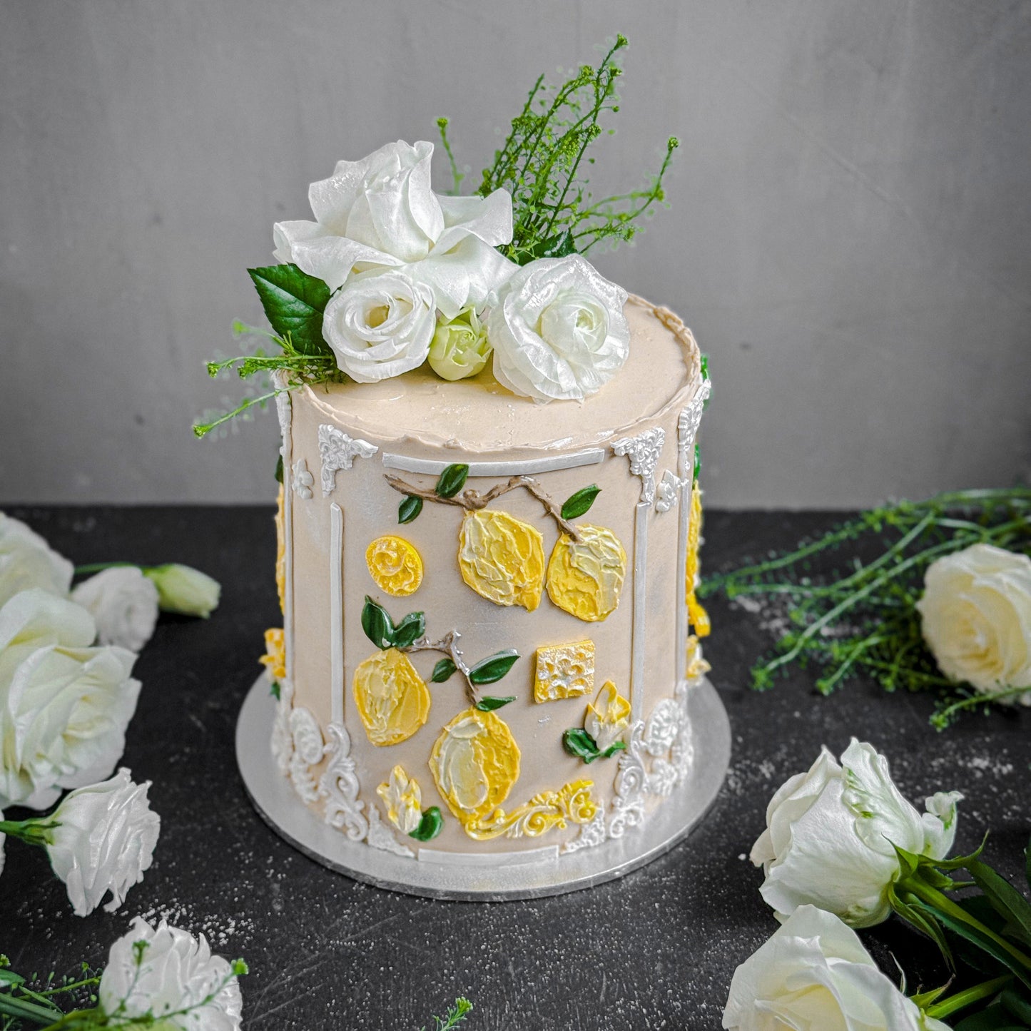 Decorative bespoke cake with floral details from Kaki Desserts, showcasing intricate icing and elegant design.