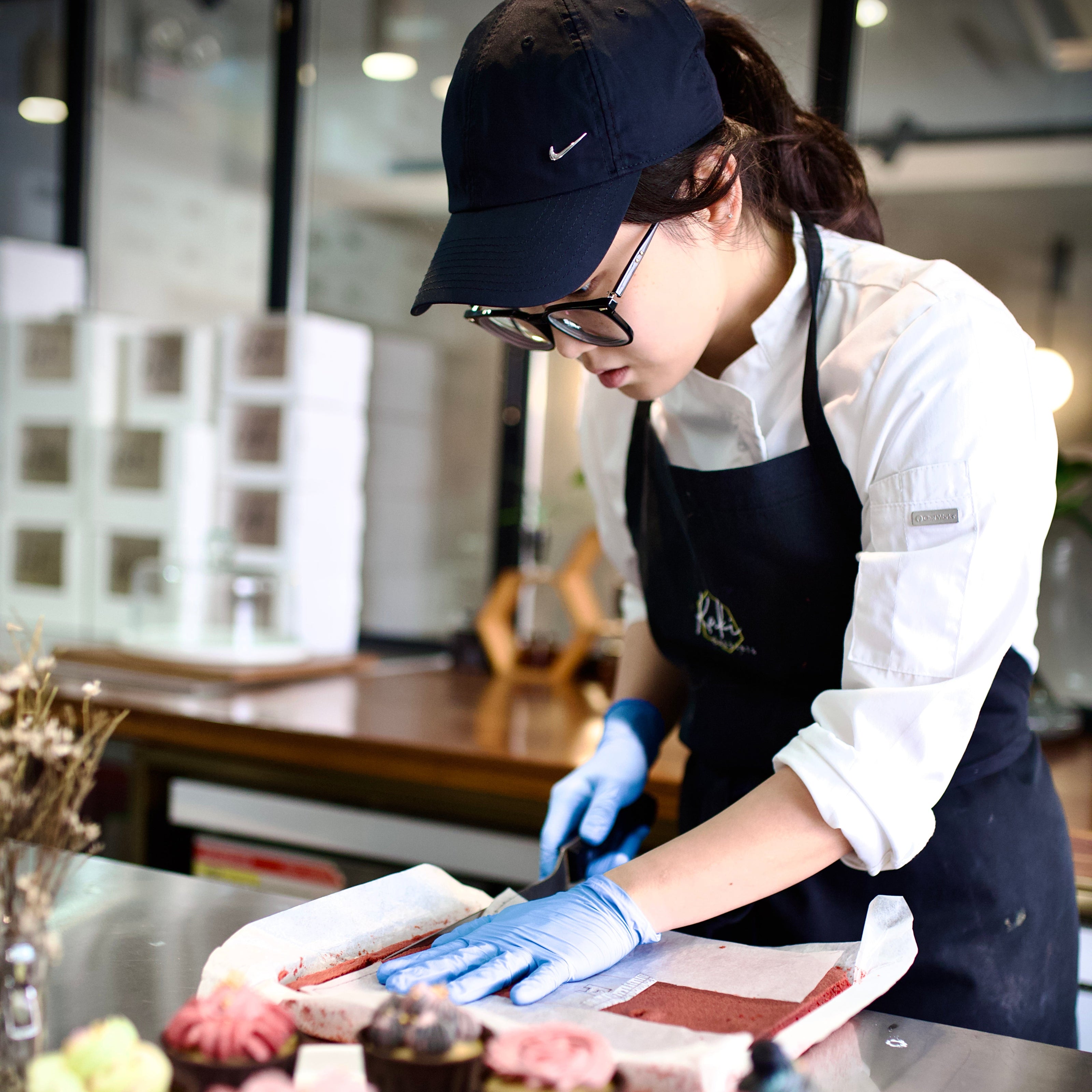 Kaki Desserts chef in a kitchen preparing desserts with a focus on the food.