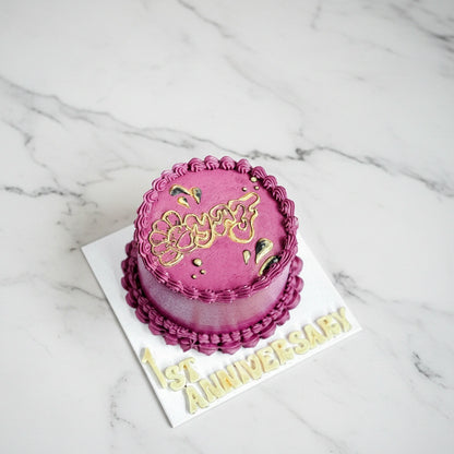Marble anniversary cake with magenta and white swirl design from Kaki Desserts, showcasing elegant bespoke dessert craftsmanship.