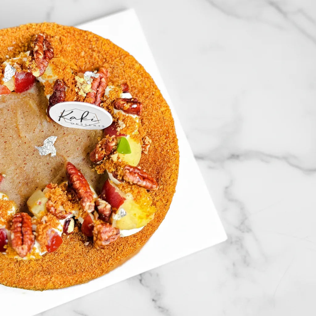 Slice of Kaki Desserts apple pecan cake featuring sliced apples and pecans on top, sugar-free dessert with a golden crust.