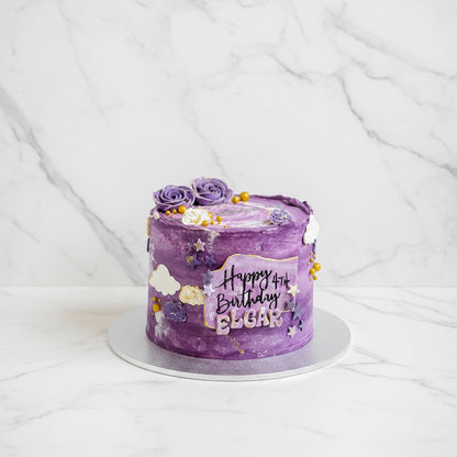 Marble galaxy-themed cake by Kaki Desserts with swirling marble frosting and cosmic galaxy design on top.