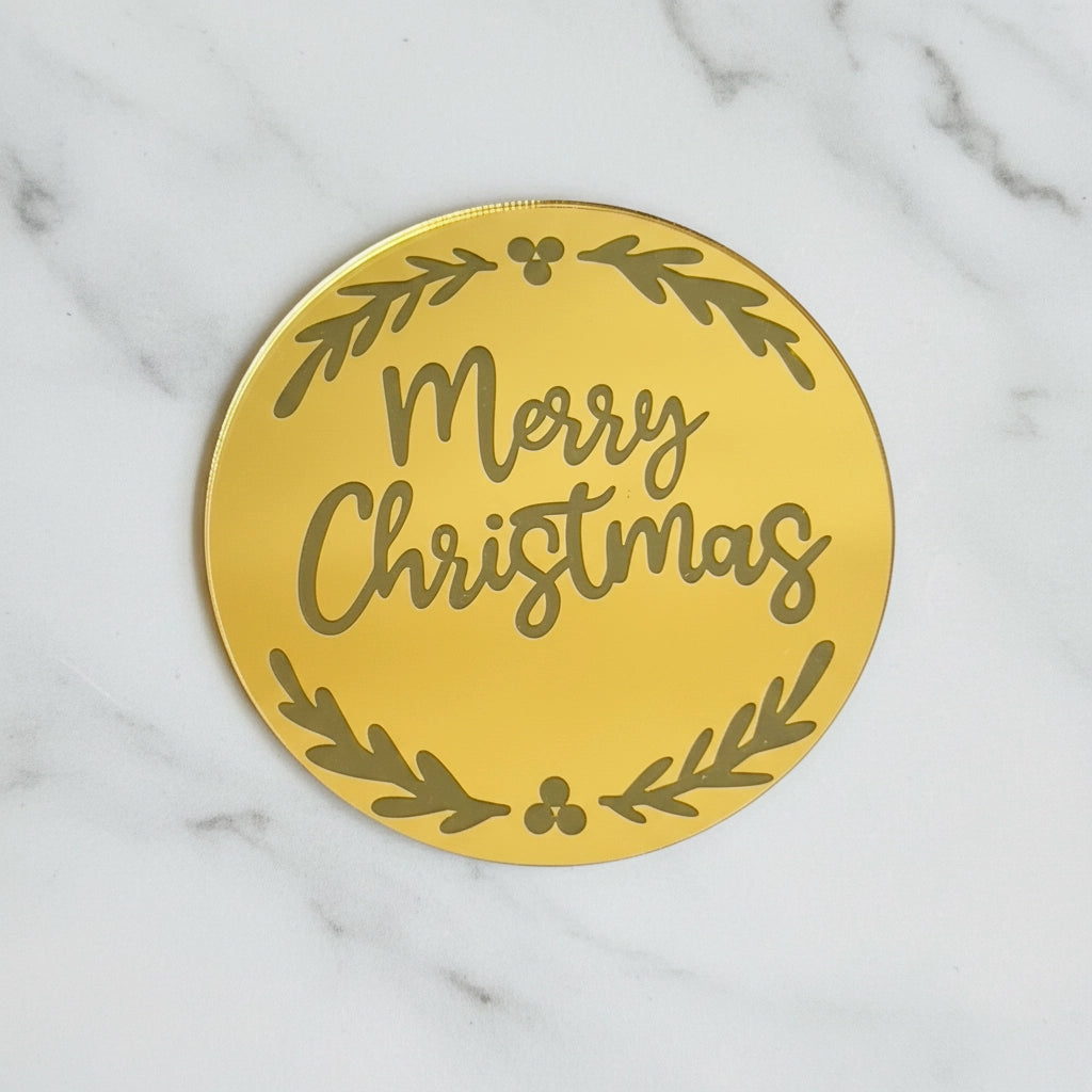 Gold Merry Christmas disc add-on from Kaki Desserts with a marble design, perfect for festive cake decorations.