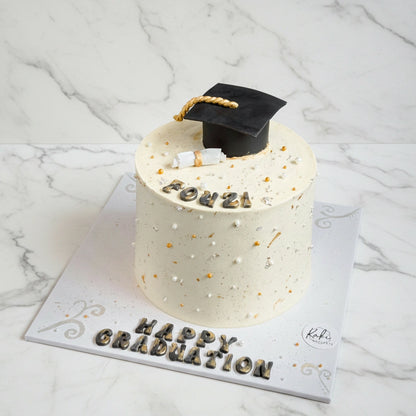 Marble graduation cake by Kaki Desserts featuring elegant marble fondant with graduation-themed decorations.