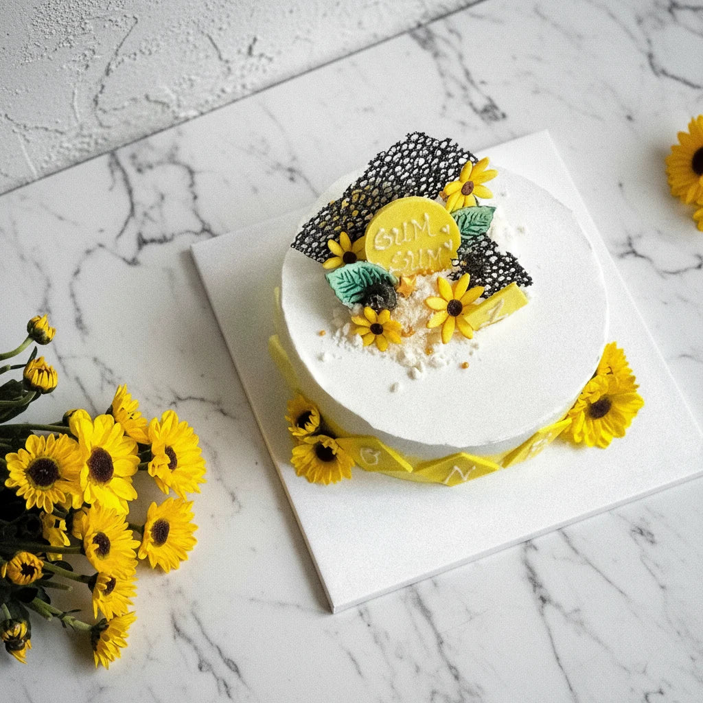 Decorative marble cake with sunflower design from Kaki Desserts' bespoke cake collection, featuring vibrant colors and intricate details.