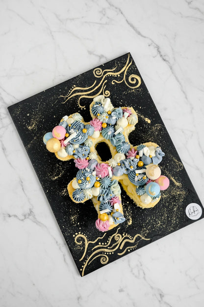 Marble letter cake from Kaki Desserts with intricate marble frosting and custom letter design, perfect for celebrations.