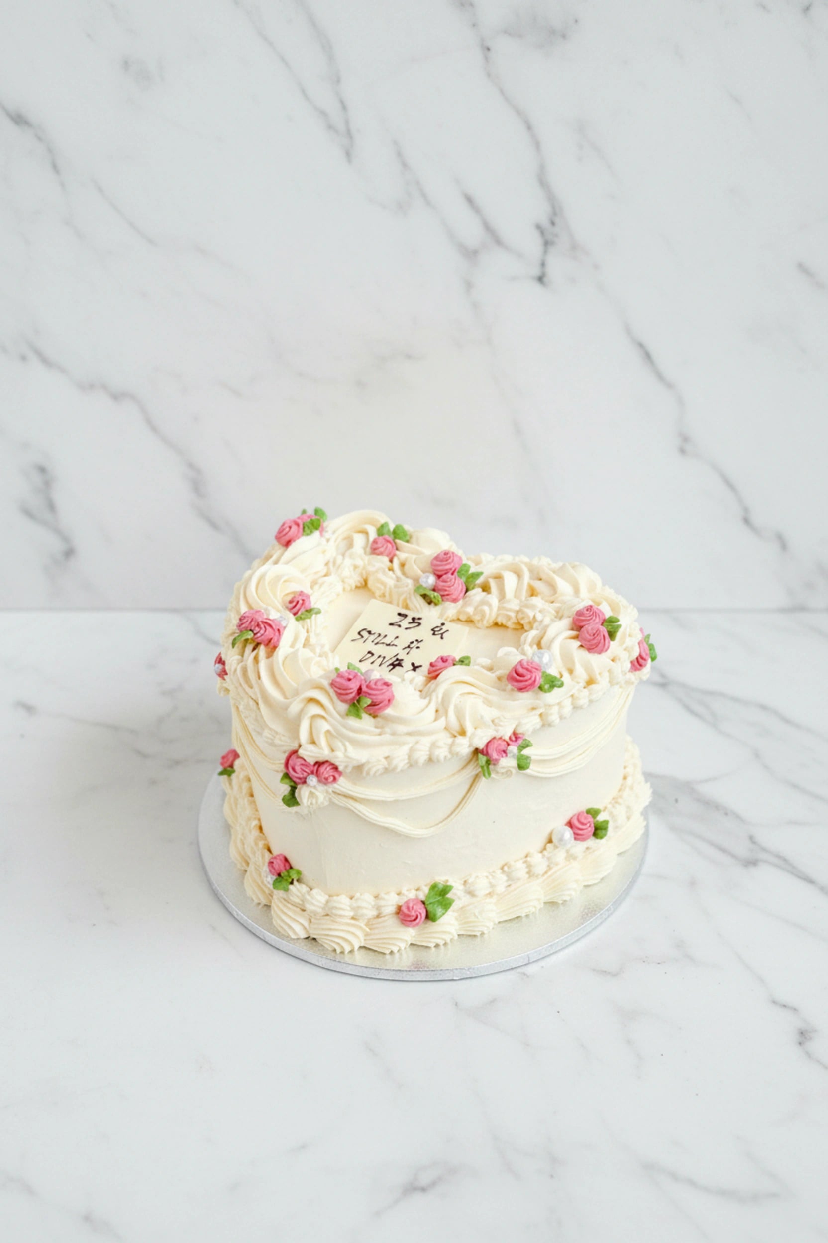 Marble heart-shaped cake from Kaki Desserts with elegant marbled frosting and intricate detailing, perfect for special occasions.