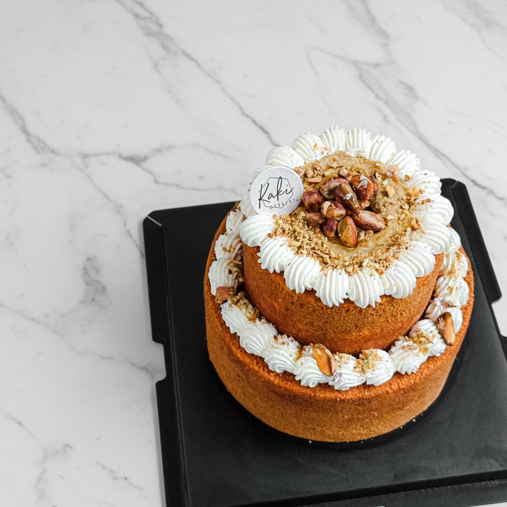 Kaki Desserts Pistachio Honey Cake with honey and almonds, featuring a marble pattern on top, sugar-free dessert.