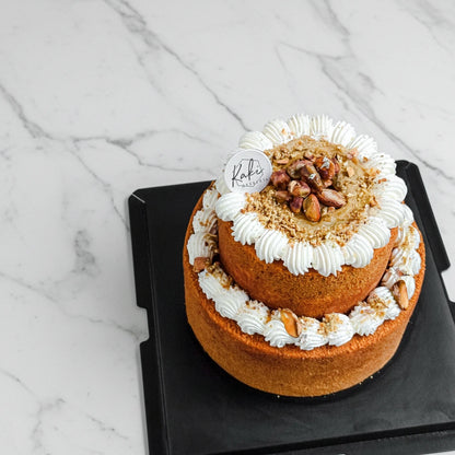 Kaki Desserts Pistachio Honey Cake with honey and almonds, featuring a marble pattern on top, sugar-free dessert.