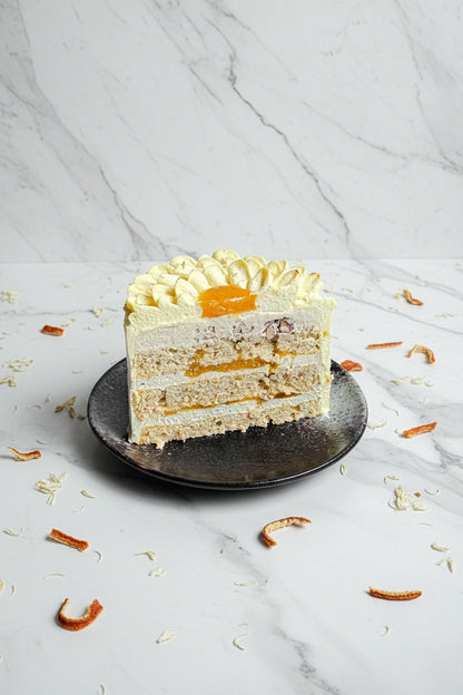 Slice of marble honey cake from Kaki Desserts, showcasing layered, marbled dessert with golden honey glaze.