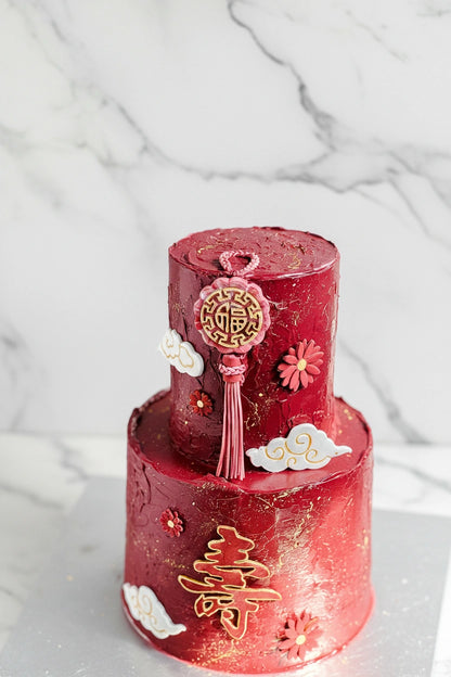 Close-up of a marble-themed tier cake by Kaki Desserts, showcasing elegant layers and detailed frosting design.