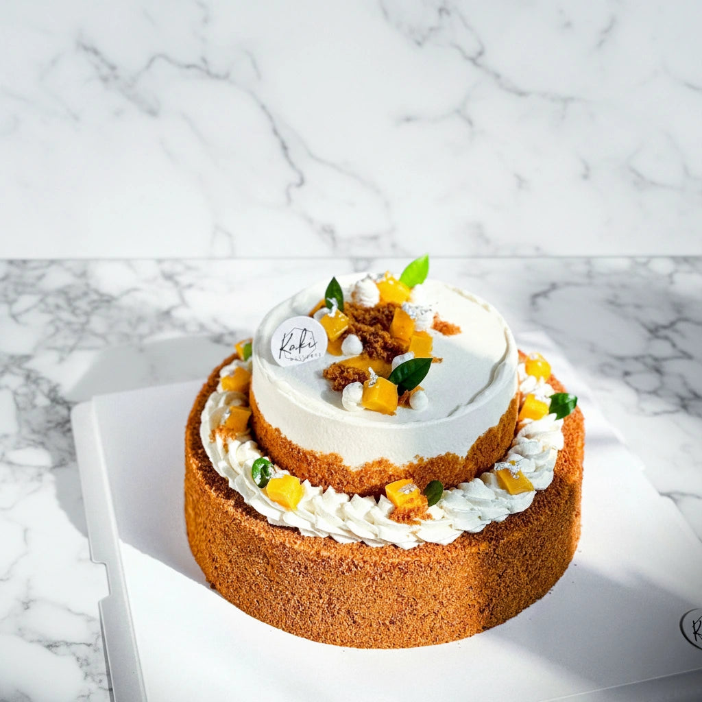Mango Float dessert by Kaki Desserts with layered mango and honey cake on a marble surface, sugar-free and sweetly layered.