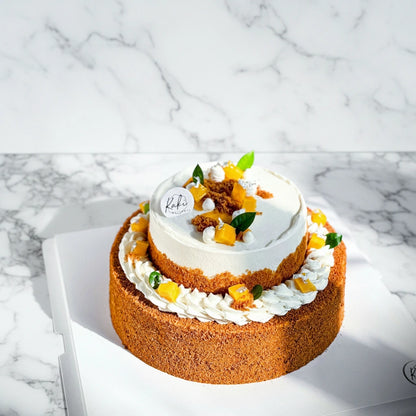 Mango Float dessert by Kaki Desserts with layered mango and honey cake on a marble surface, sugar-free and sweetly layered.