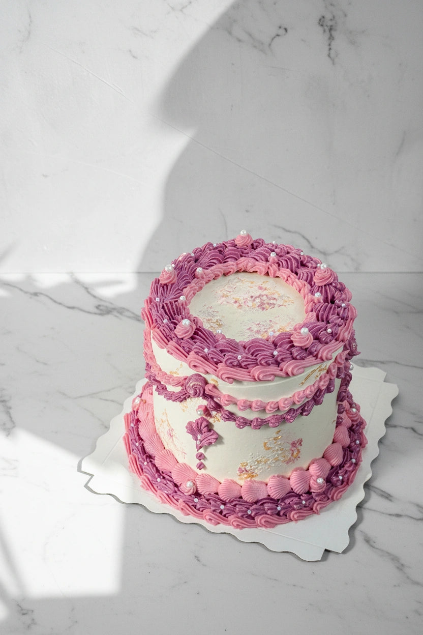Close-up of a pink marble wave cake by Kaki Desserts, showcasing intricate marble design and smooth pink frosting.