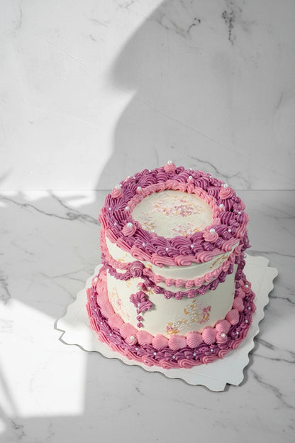 Close-up of a pink marble wave cake by Kaki Desserts, showcasing intricate marble design and smooth pink frosting.