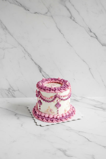 Pink marble wave-shaped bespoke cake by Kaki Desserts, featuring elegant marbling and artistic design for special occasions.