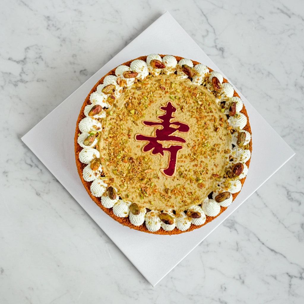 Kaki Desserts pistachio honey cake with marble pattern, sugar-free and rich in pistachio flavor, displayed on a white plate.