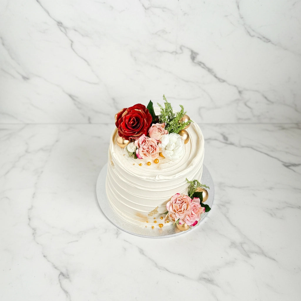 Marble cake decorated with red roses from Kaki Desserts, showcasing elegant bespoke cake design and floral decoration.