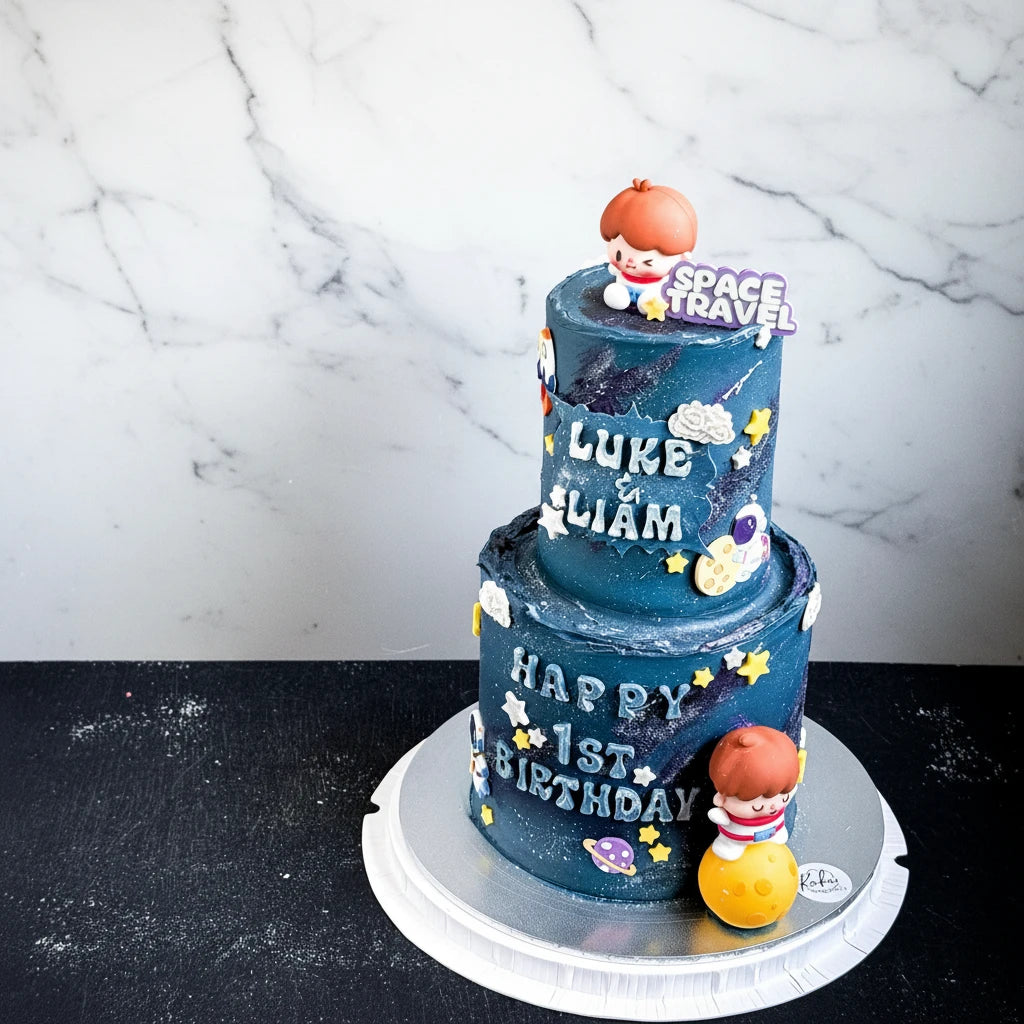 Marble space travel-themed cake from Kaki Desserts with colorful space and planet decorations on a tiered cake.