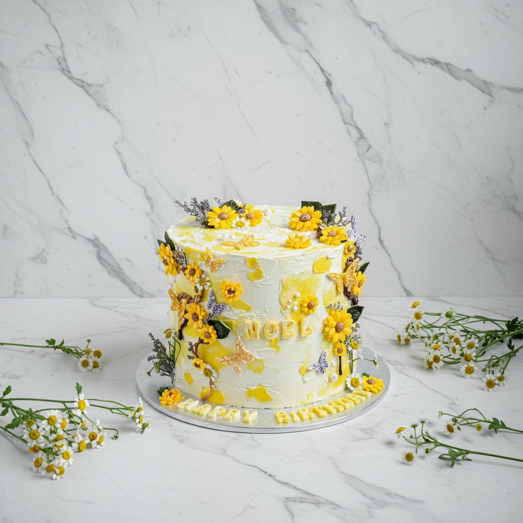 Marble sunflower cake from Kaki Desserts featuring a marbled design with sunflower-shaped decorations on top.