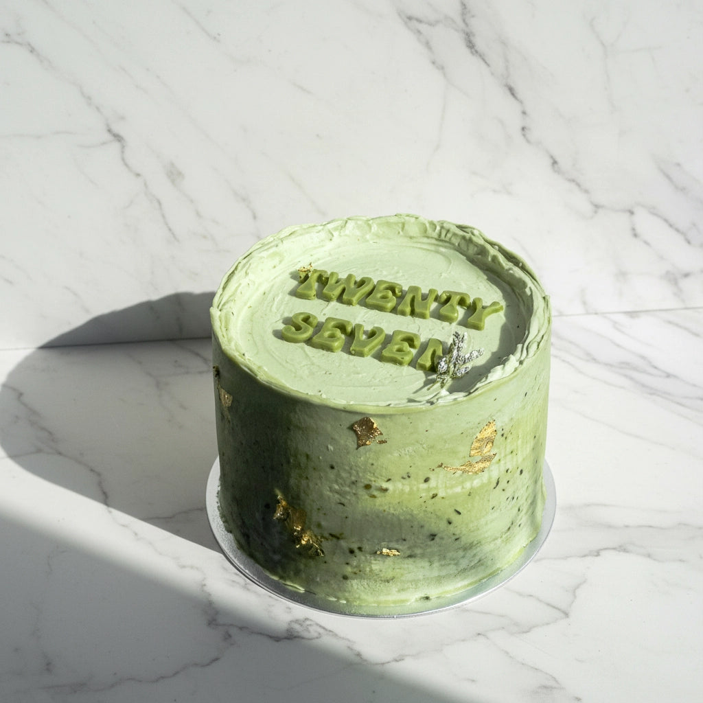Kaki Desserts matcha marble cake with layered green and white marbled frosting, showcasing a beautifully crafted bespoke cake.