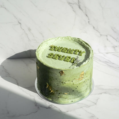Kaki Desserts matcha marble cake with layered green and white marbled frosting, showcasing a beautifully crafted bespoke cake.