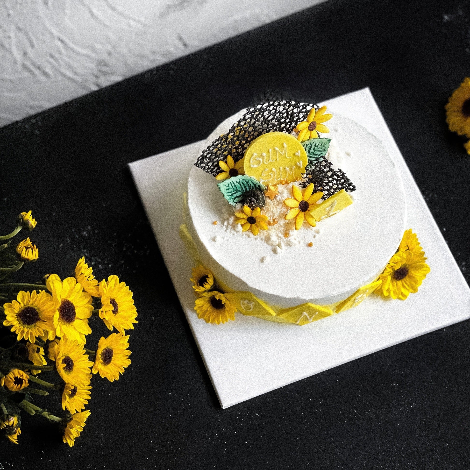 Decorative sunflower cake from Kaki Desserts featuring vibrant yellow sunflower design on a beautifully crafted bespoke cake.